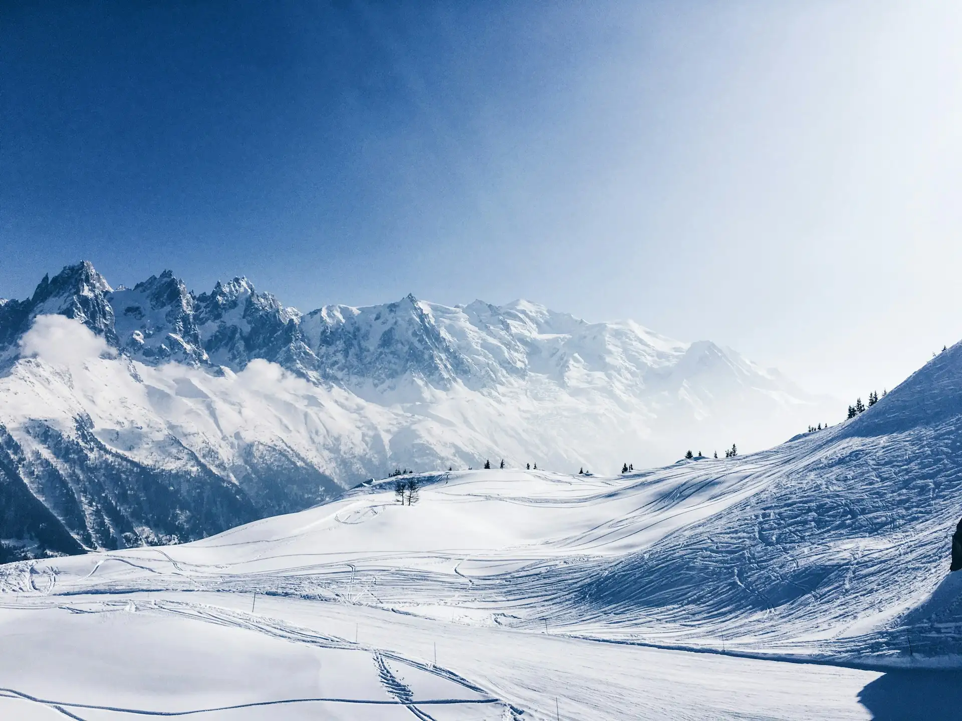 Snow-covered ski slopes in Chamonix-Mont-Blanc, with a panoramic view of the Mont-Blanc massif